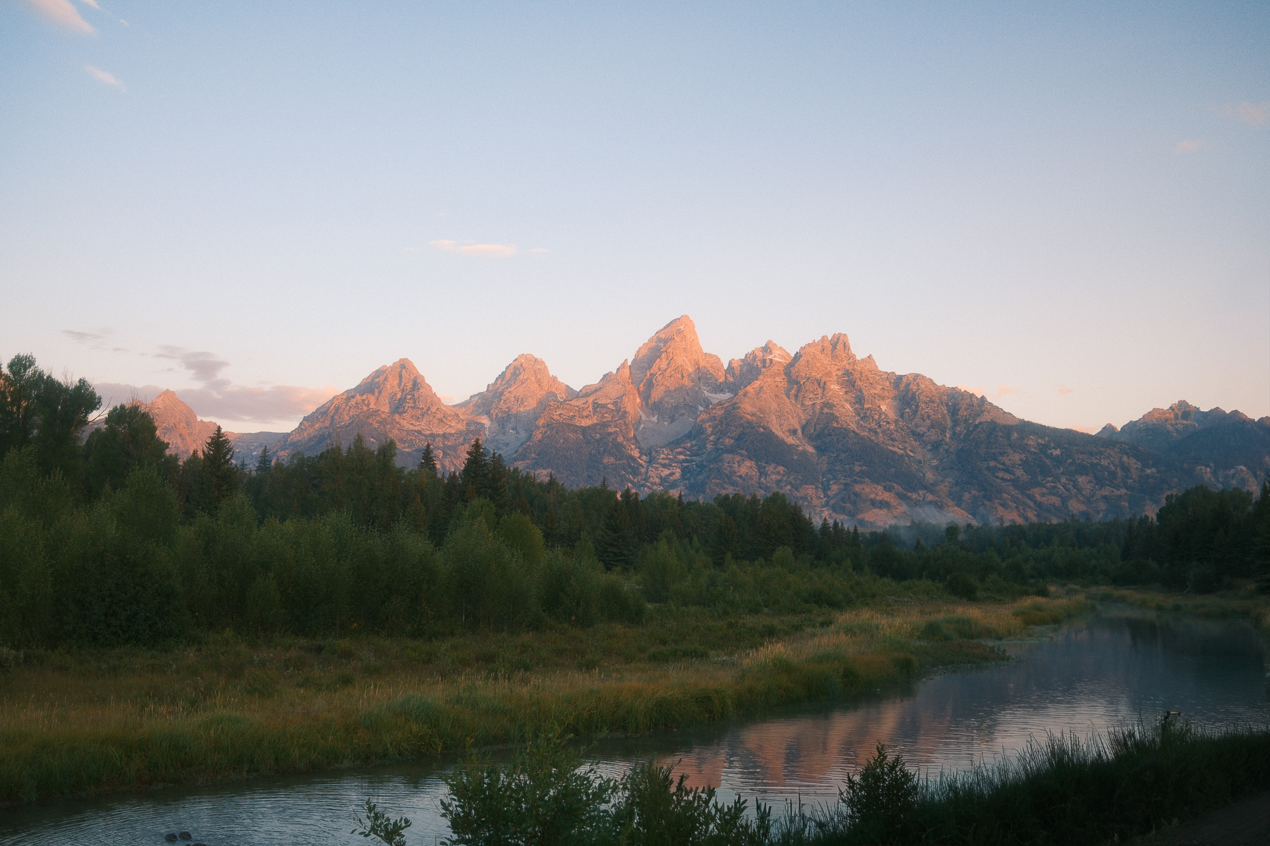 Sunrise over the Teton Range reflected in the Snake River at Schwabacher Landing in Grand Teton National Park.