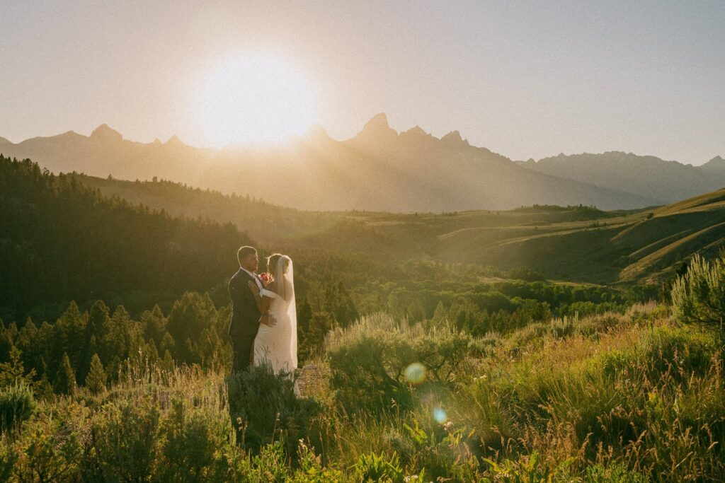 Sunset wedding portrait of an eloping couple at the Wedding Tree in Bridger-Teton National Forest with panoramic views of Grand Teton.